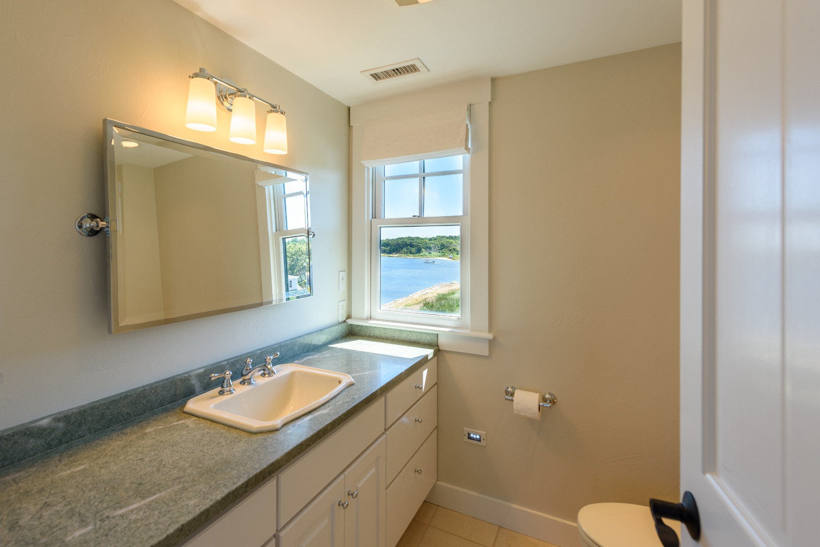 25 The Boulevard Edgartown, MA 02539 - Photo 23 of 40 a bathroom with a granite countertop sink mirror and a toilet