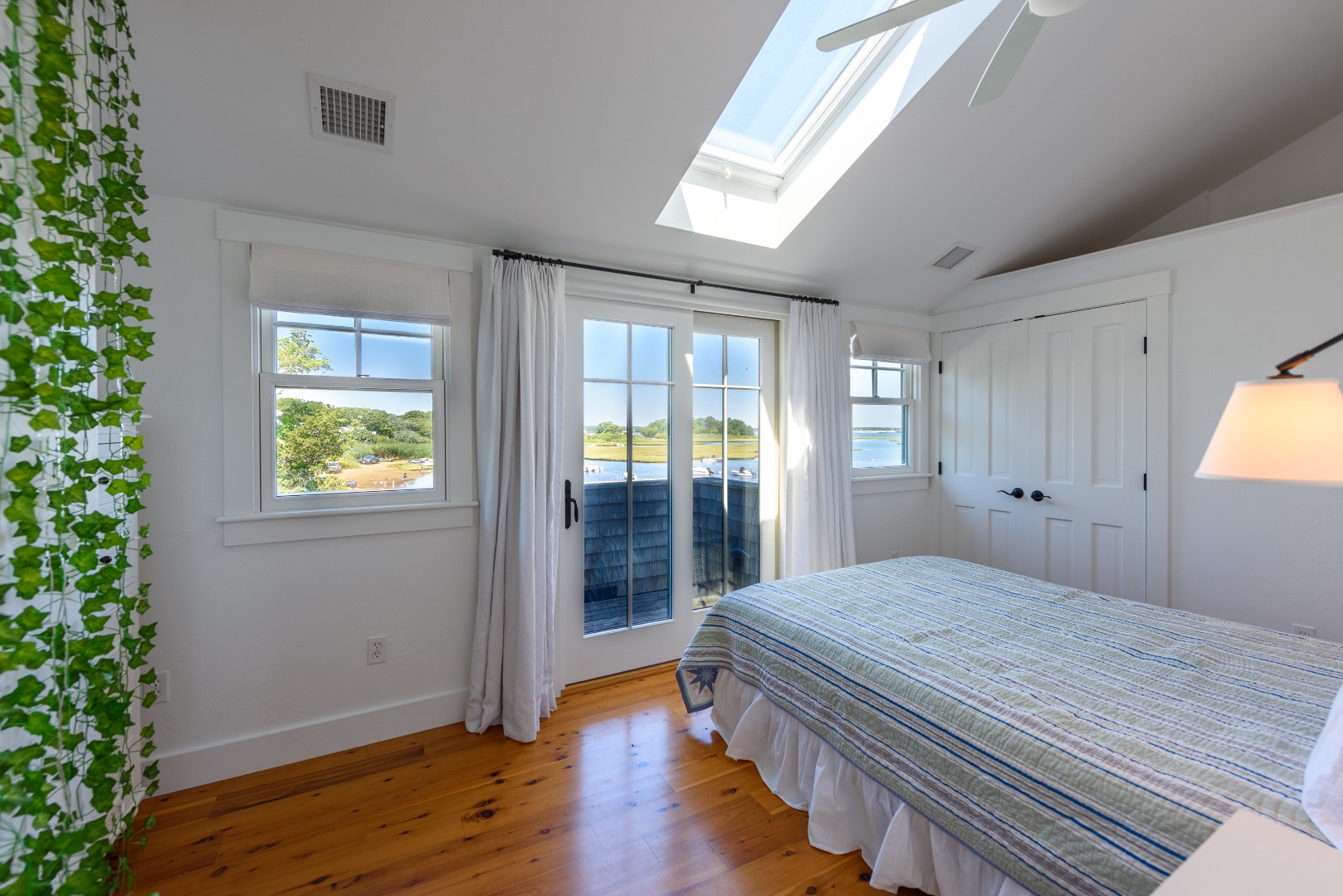 25 The Boulevard Edgartown, MA 02539 - Photo 25 of 40 a bedroom with a bed and wooden floor