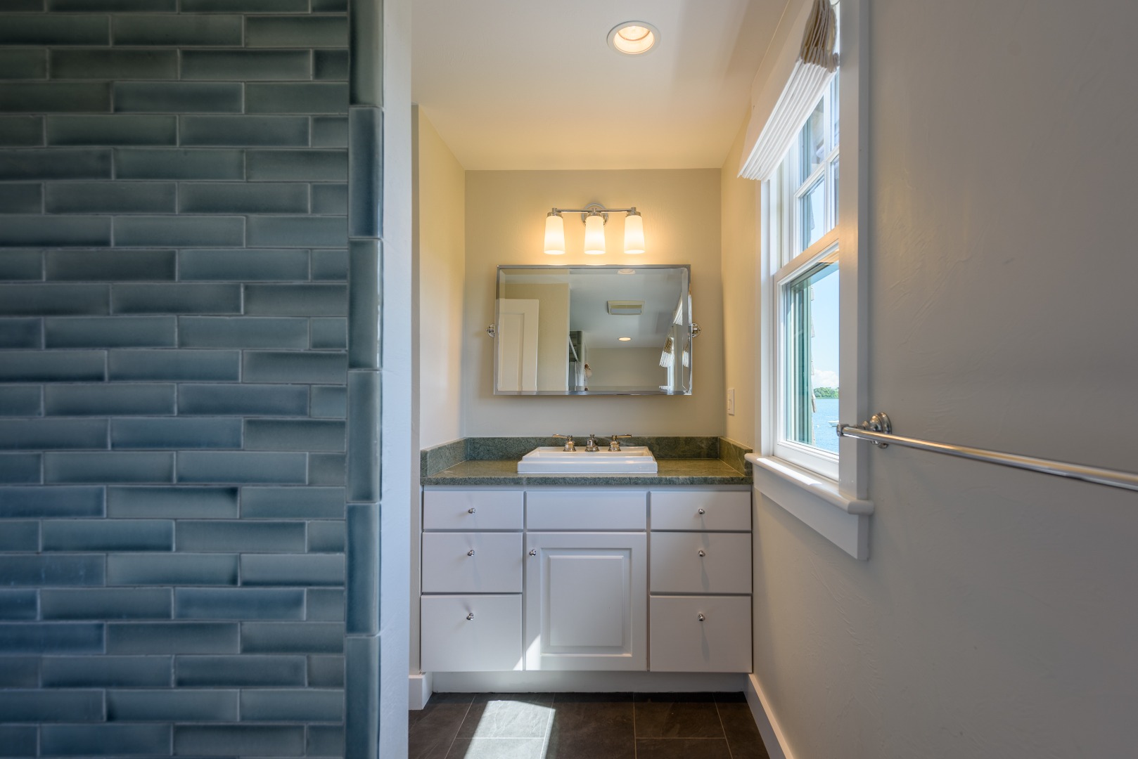 25 The Boulevard Edgartown, MA 02539 - Photo 30 of 40 a bathroom with a granite countertop sink and a mirror