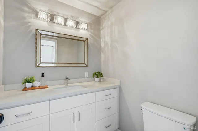a bathroom with a toilet sink and mirror