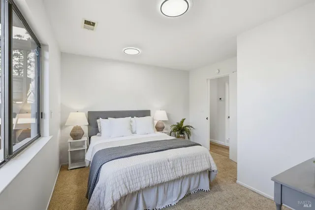 a bedroom with a bed and window