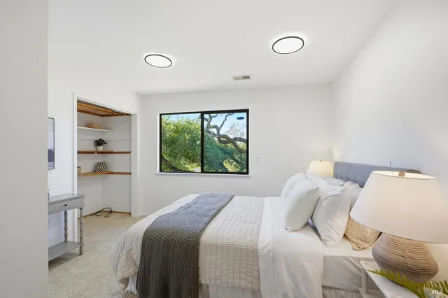 a bedroom with a bed and a window