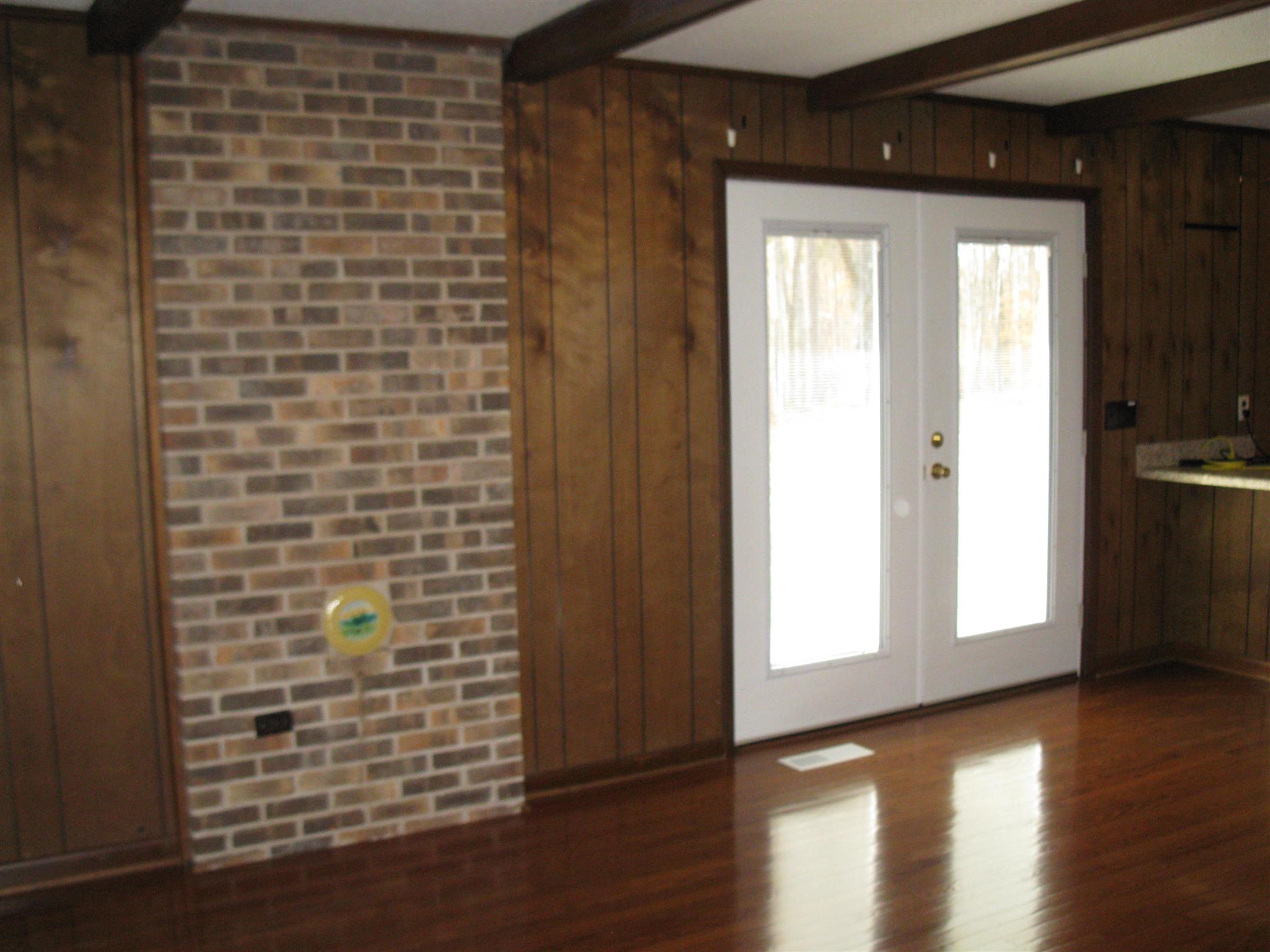 773 Cathey Ridge Road Manchester, TN 37355 - Photo 5 of 23 a view of an empty room with wooden floor and a window
