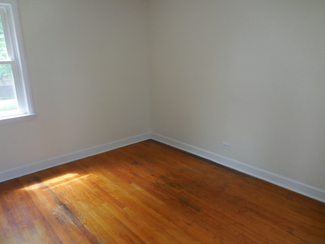 4723 Butterfield Road Hillside, IL 60162 - Photo 7 of 10 an empty room with wooden floor and windows