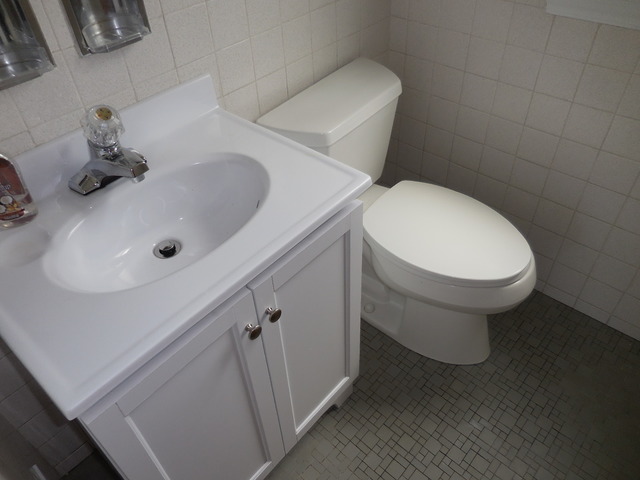 4723 Butterfield Road Hillside, IL 60162 - Photo 9 of 10 a bathroom with a toilet sink and mirror