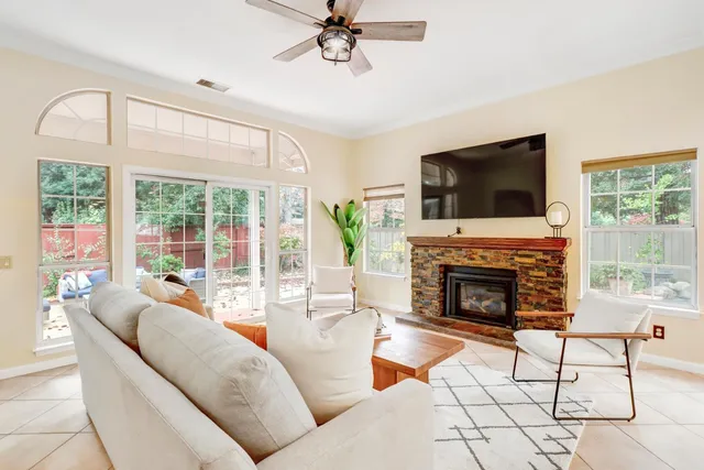a living room with a bed furniture and a wooden floor