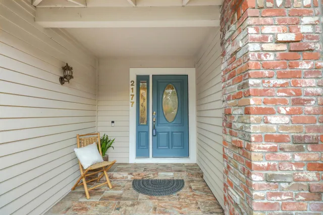 a living room with furniture a fireplace and a large window