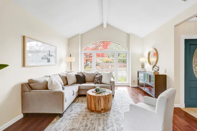 a dining room with furniture potted plants and wooden floor