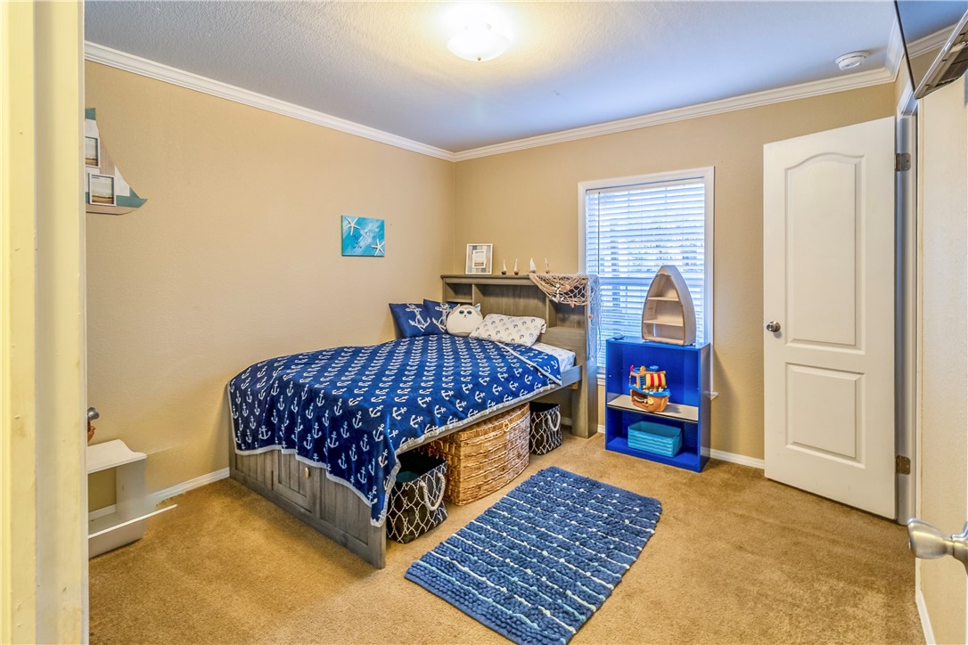 6258 North Hill Road Navasota, TX 77868 - Photo 23 of 30 a bedroom with a bed and wooden floor