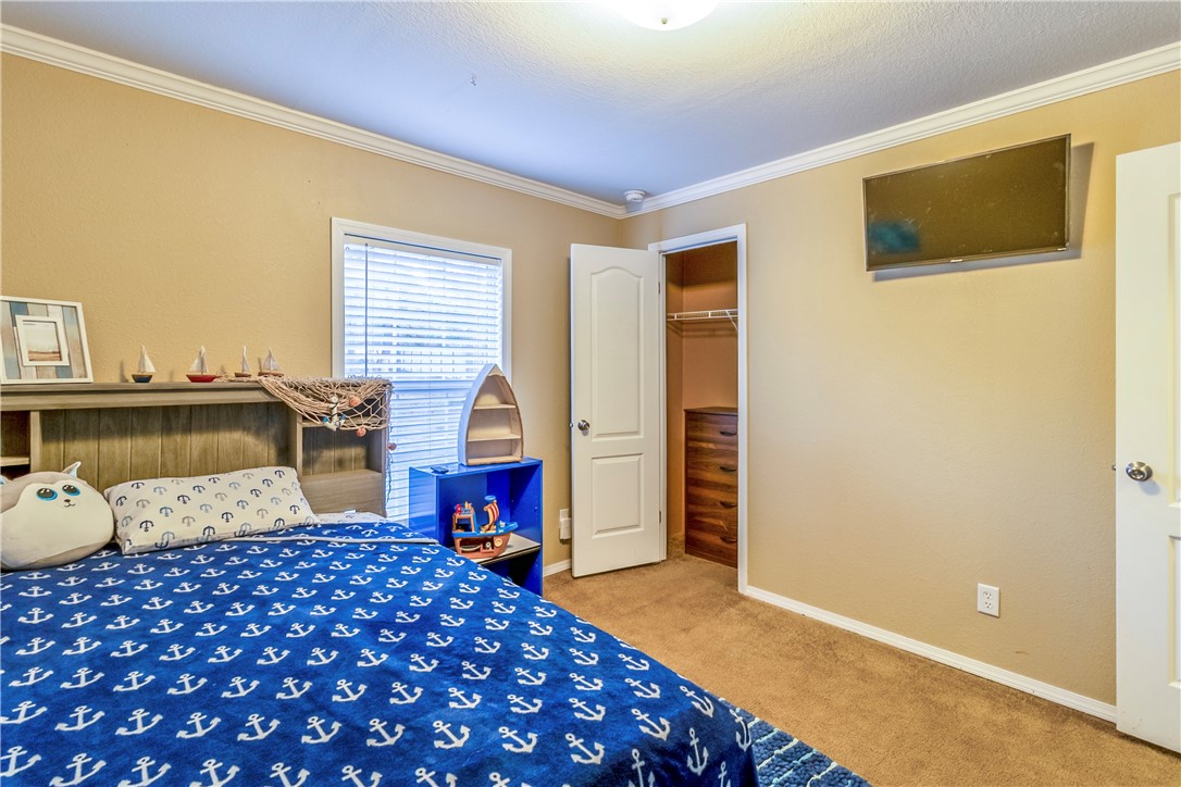 6258 North Hill Road Navasota, TX 77868 - Photo 24 of 30 a bedroom with a bed and wooden floor