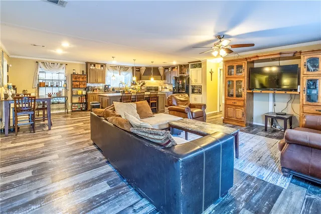 a large living room with stainless steel appliances granite countertop a living room and wooden floors