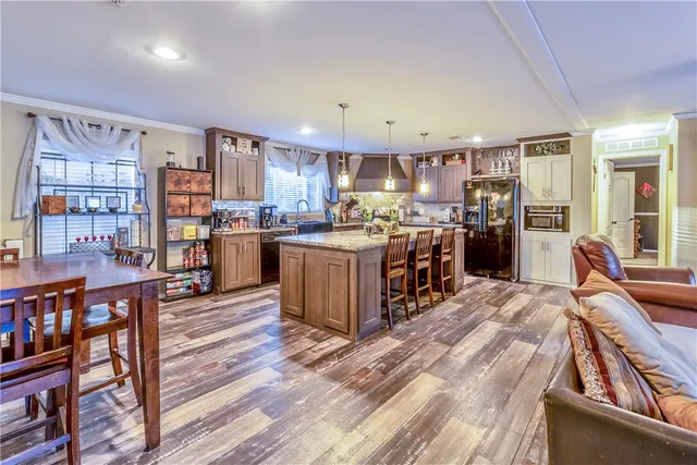 a open kitchen with stainless steel appliances granite countertop a stove and a refrigerator