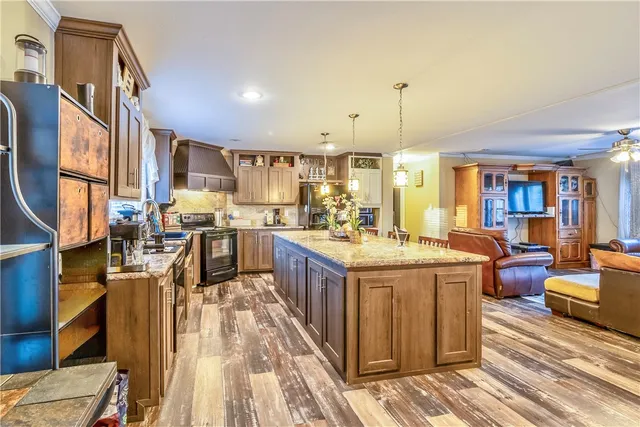 a kitchen with stainless steel appliances granite countertop a stove and more cabinets