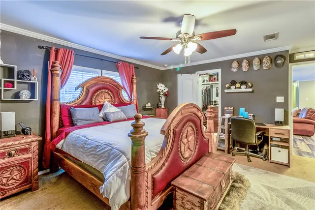 a bedroom with bed and a chandelier