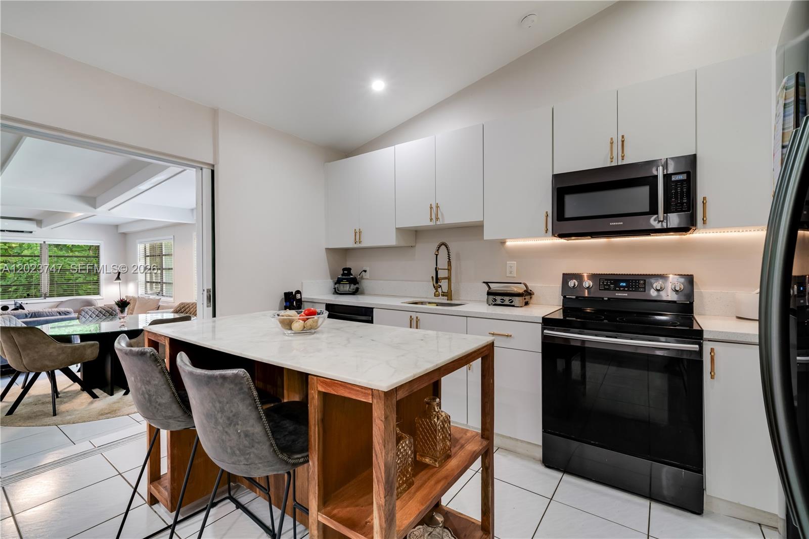 11515 Southwest 81st Road, Unit 11515 Pinecrest, FL 33156 - Photo 10 of 33 a kitchen with a stove a sink and a refrigerator