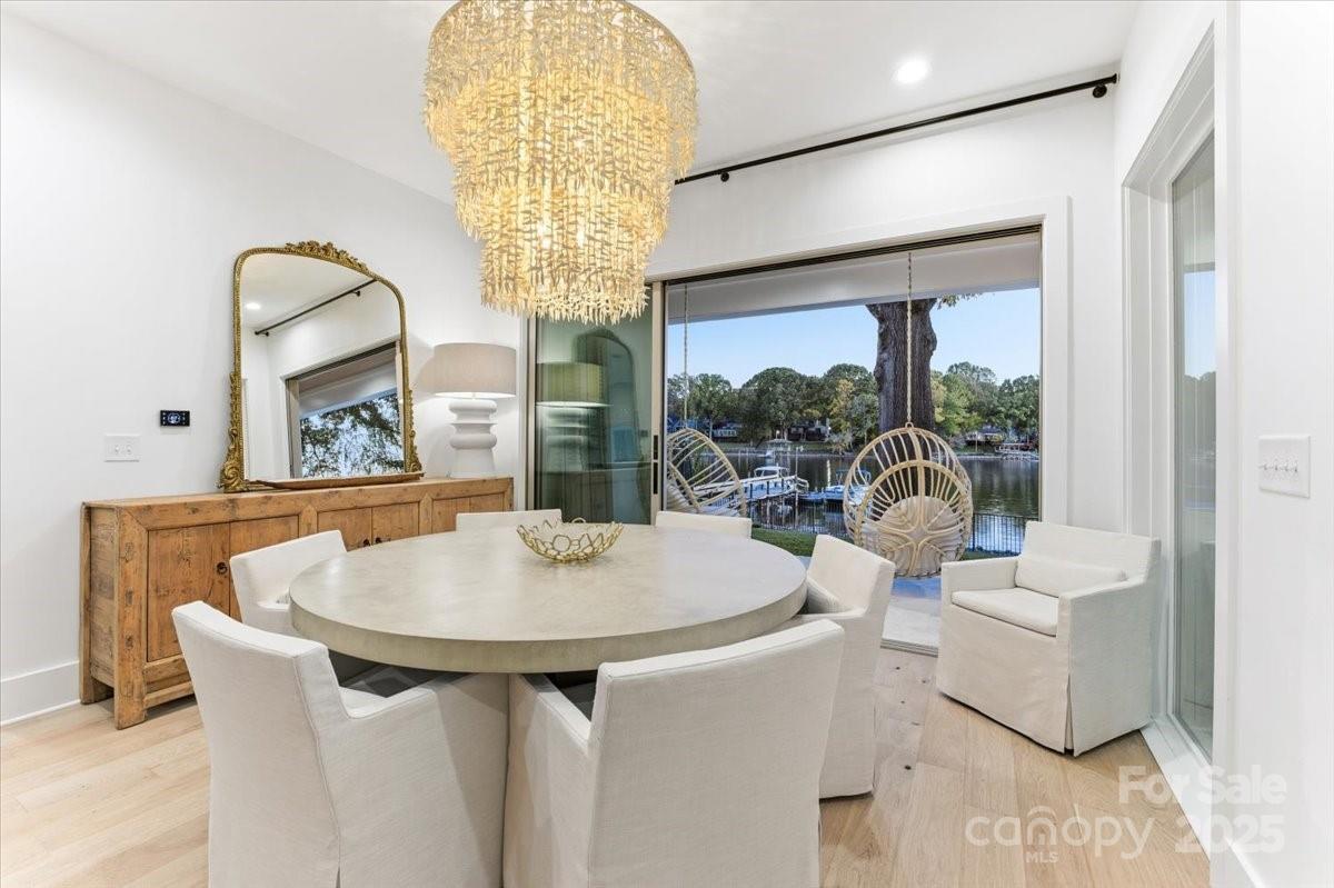21520 Rio Oro Drive Cornelius, NC 28031 - Photo 16 of 43 a dining room with furniture a chandelier and wooden floor