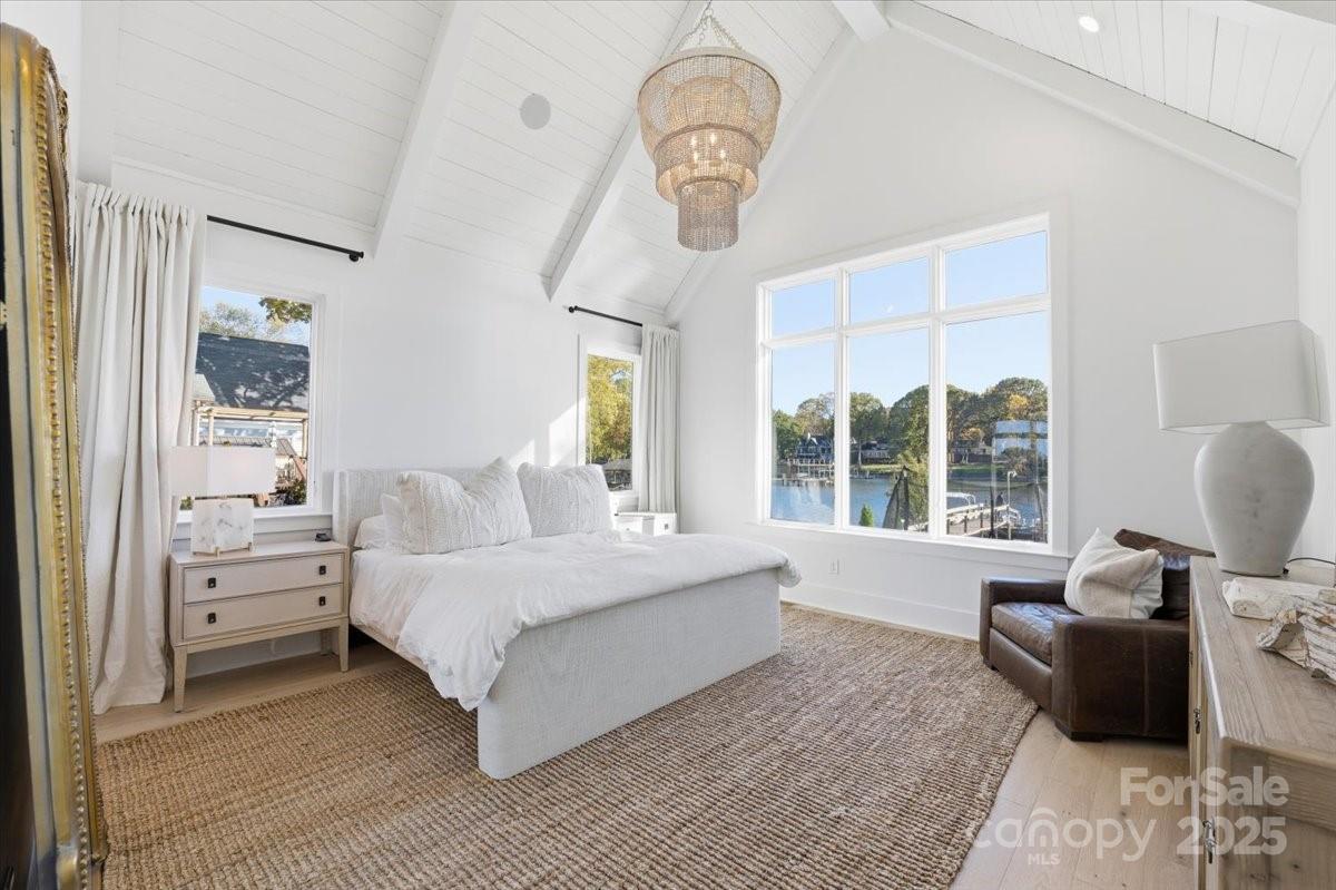 21520 Rio Oro Drive Cornelius, NC 28031 - Photo 17 of 43 a spacious bedroom with a bed couch and a window