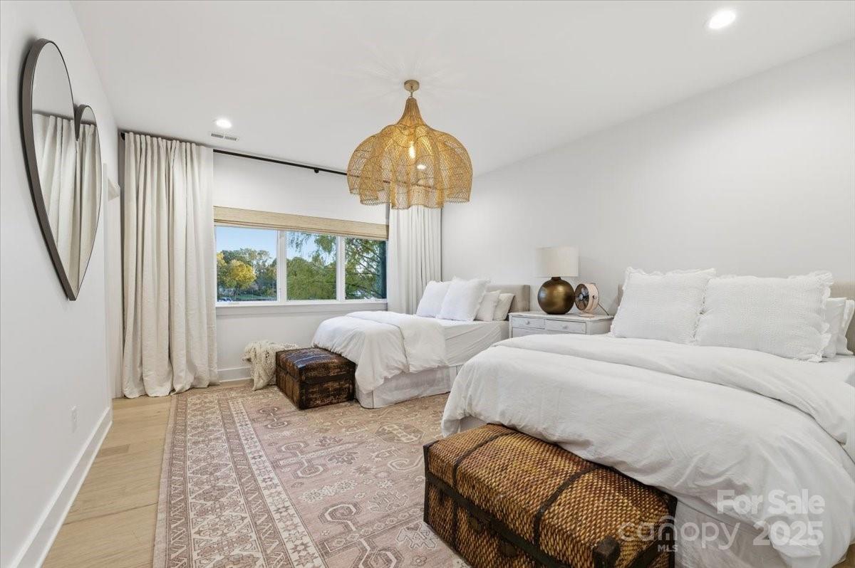 21520 Rio Oro Drive Cornelius, NC 28031 - Photo 25 of 43 a bedroom with a bed and a chandelier