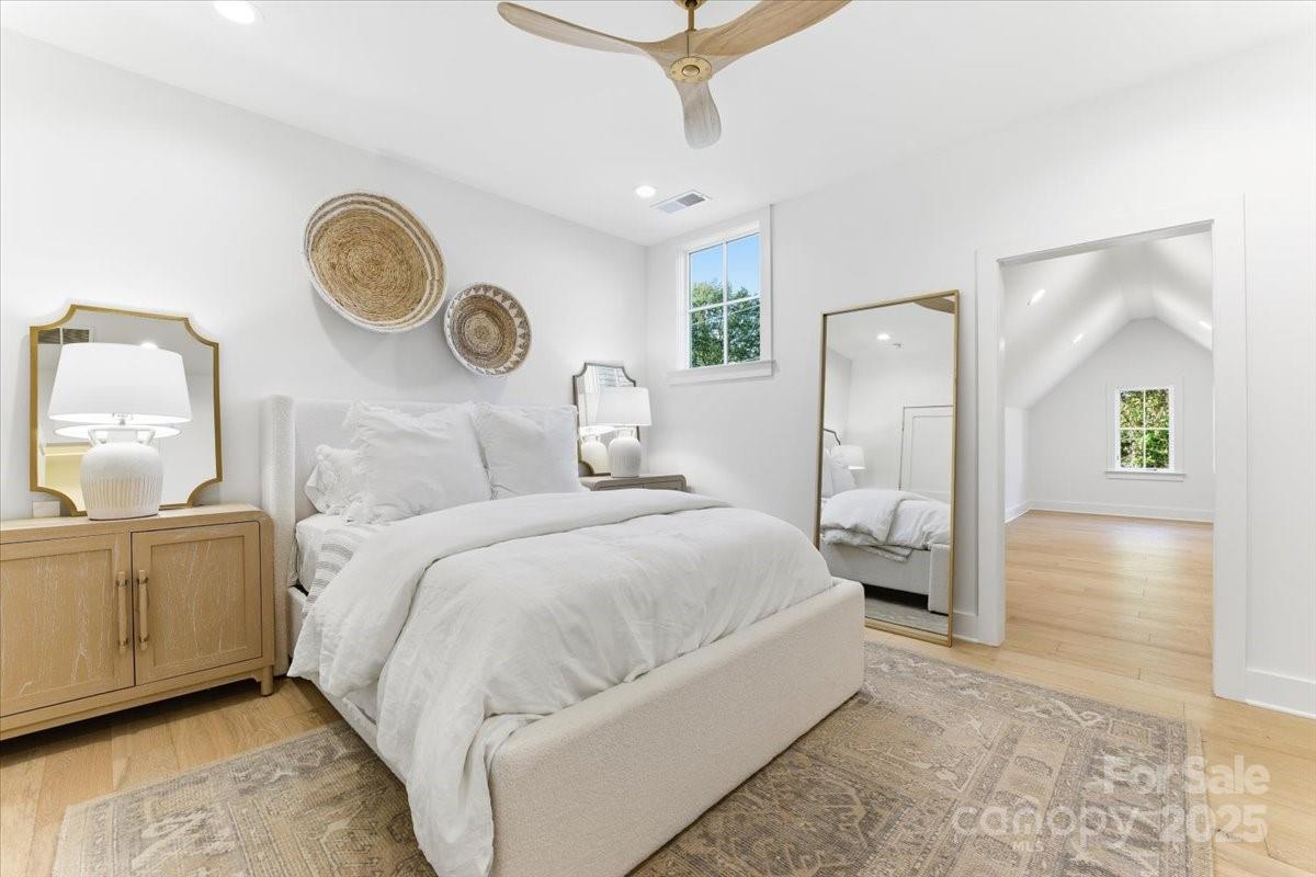 21520 Rio Oro Drive Cornelius, NC 28031 - Photo 33 of 43 a bedroom with a large bed and a chandelier