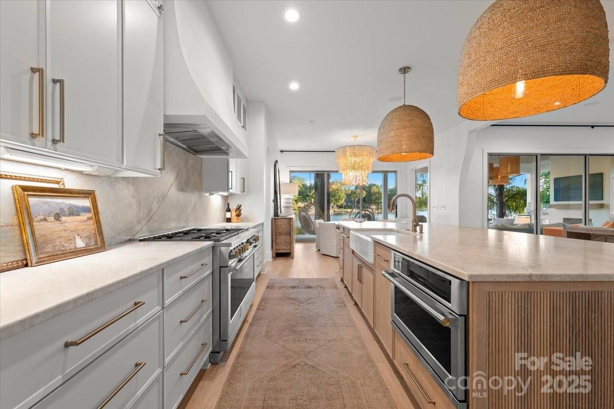 21520 Rio Oro Drive Cornelius, NC 28031 - Photo 9 of 43 a large kitchen with stainless steel appliances granite countertop a lot of counter space and a sink
