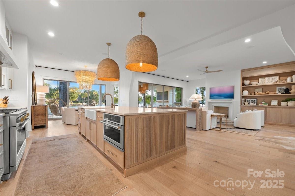 21520 Rio Oro Drive Cornelius, NC 28031 - Photo 10 of 43 a kitchen with stainless steel appliances granite countertop a stove a sink and a refrigerator