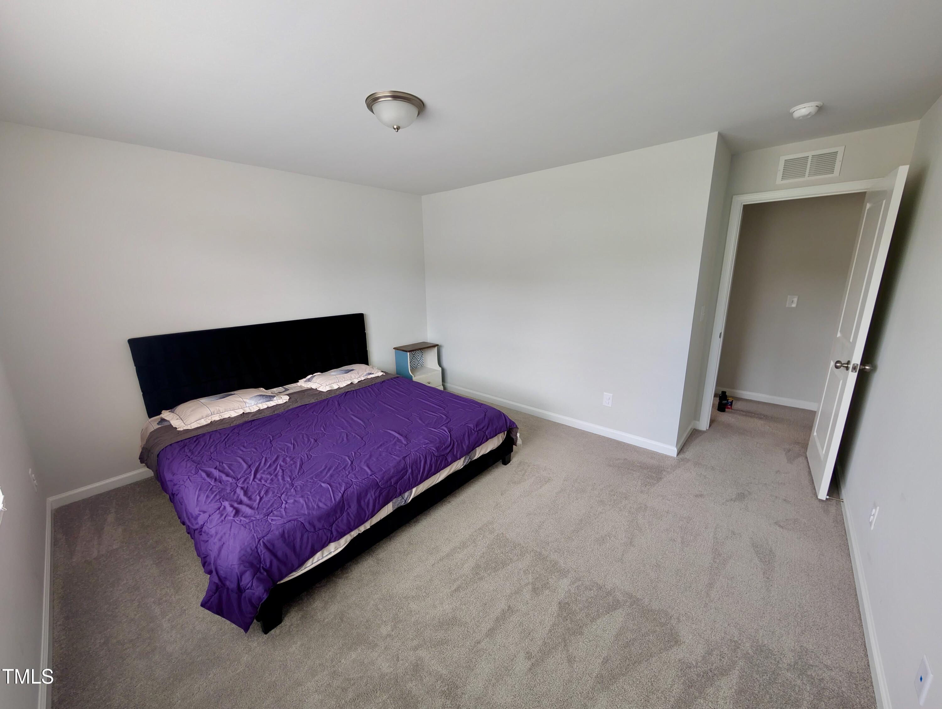 3300 Star Gazing Lane Durham, NC 27703 - Photo 12 of 31 a bedroom with a bed and a night stand
