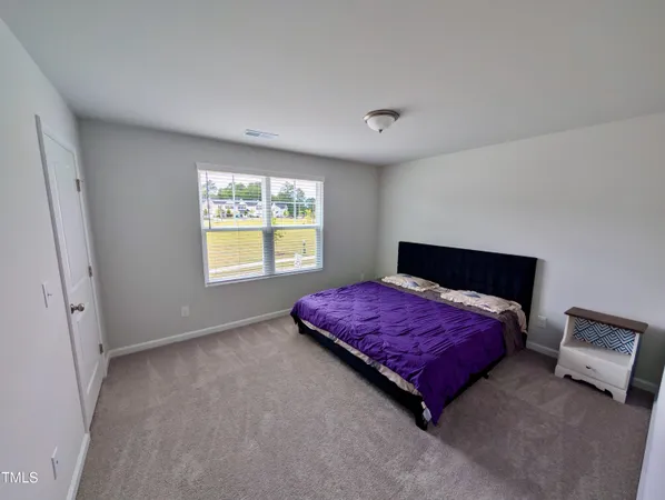 a bedroom with a bed and window