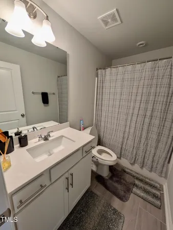 a bathroom with a sink a toilet and mirror