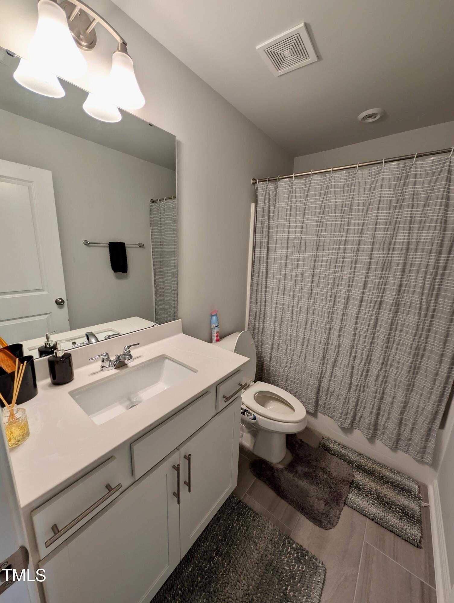3300 Star Gazing Lane Durham, NC 27703 - Photo 15 of 31 a bathroom with a sink a toilet and mirror