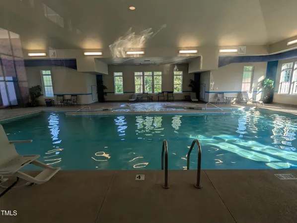 a view of a swimming pool with a yard