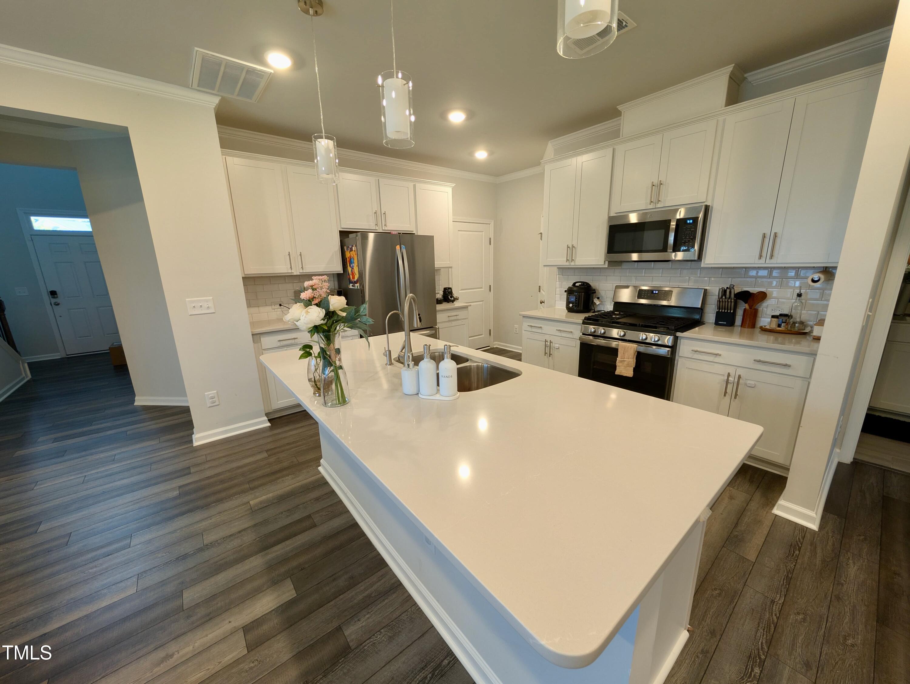 3300 Star Gazing Lane Durham, NC 27703 - Photo 3 of 31 a large white kitchen with wooden floor