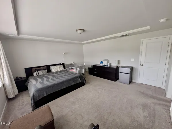 a bedroom with a bed and dresser