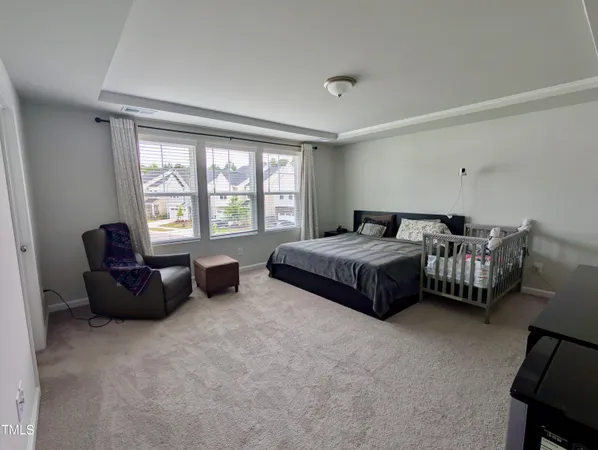 a spacious bedroom with a bed and a couch