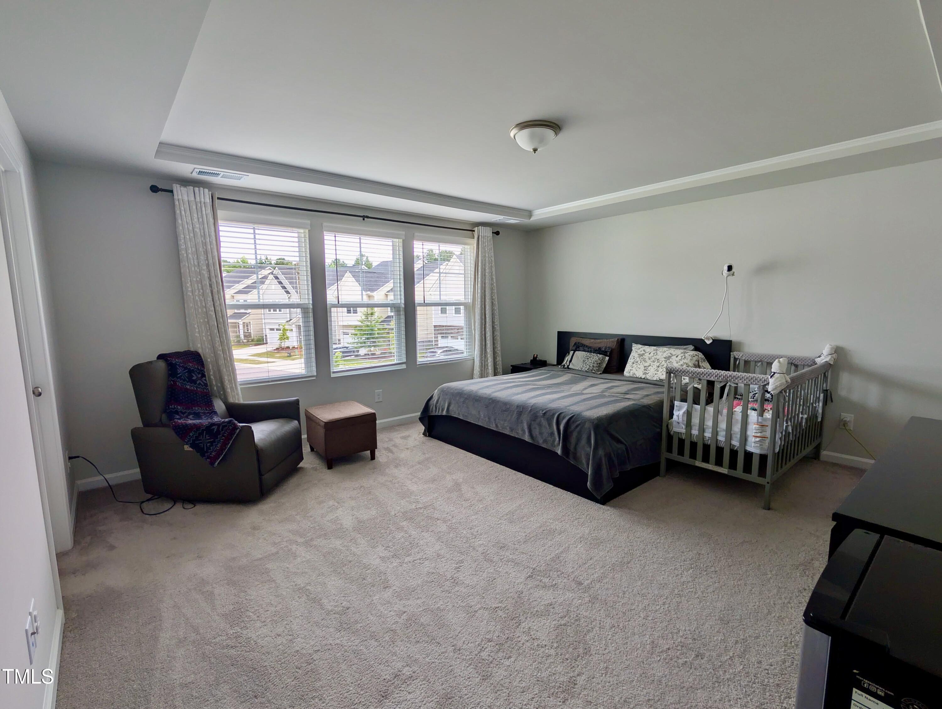 3300 Star Gazing Lane Durham, NC 27703 - Photo 8 of 31 a spacious bedroom with a bed and a couch