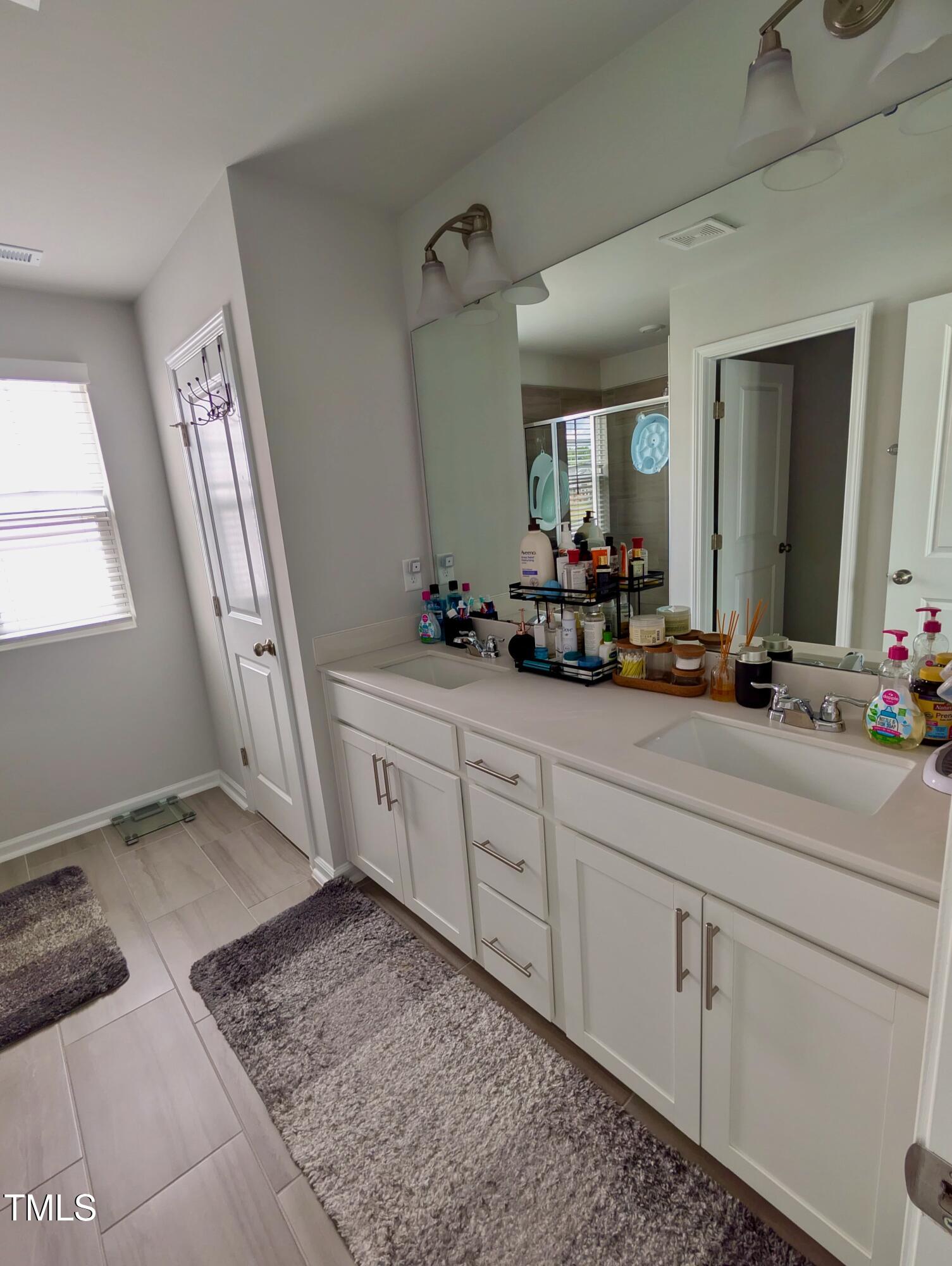 3300 Star Gazing Lane Durham, NC 27703 - Photo 10 of 31 a spacious bathroom with a granite countertop sink and a mirror