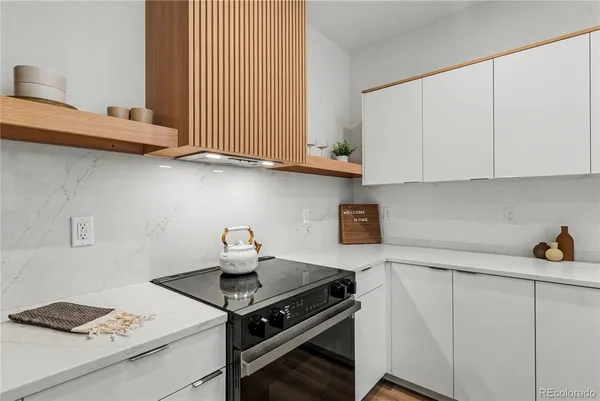 a kitchen with cabinets and a stove top oven