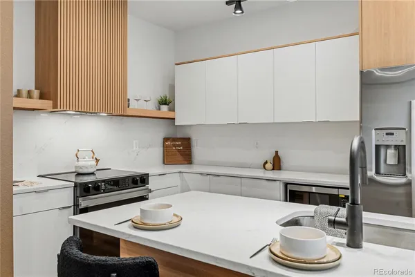 a kitchen with a sink a stove and cabinets