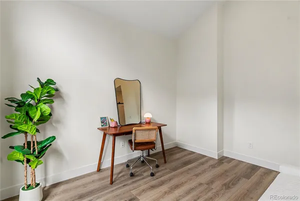 a view of a workspace with furniture and a potted plant