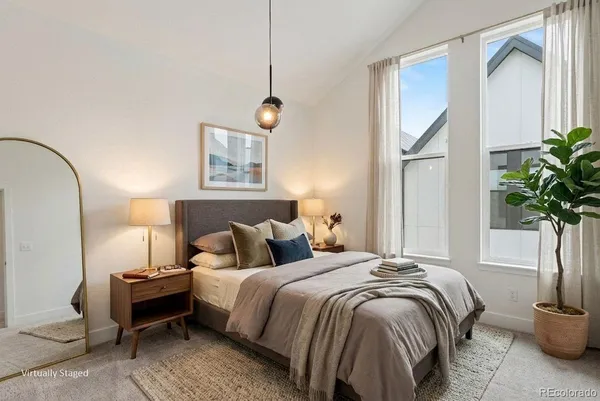 a bedroom with bed and a potted plant