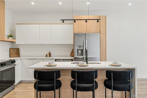 a kitchen with a table chairs stove and cabinets