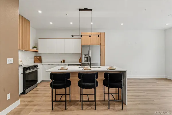 a kitchen with stainless steel appliances granite countertop a sink and a stove