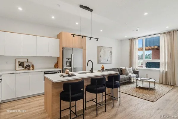 a kitchen with stainless steel appliances kitchen island granite countertop a sink and cabinets