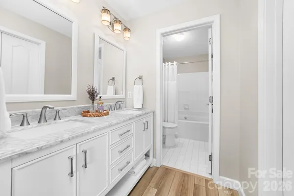a bathroom with a granite countertop sink mirror and double