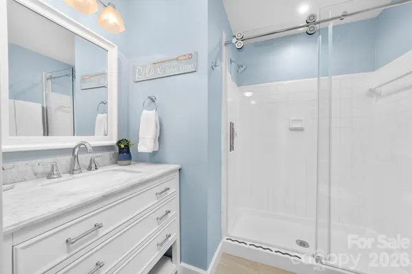 a bathroom with a granite countertop sink mirror and double