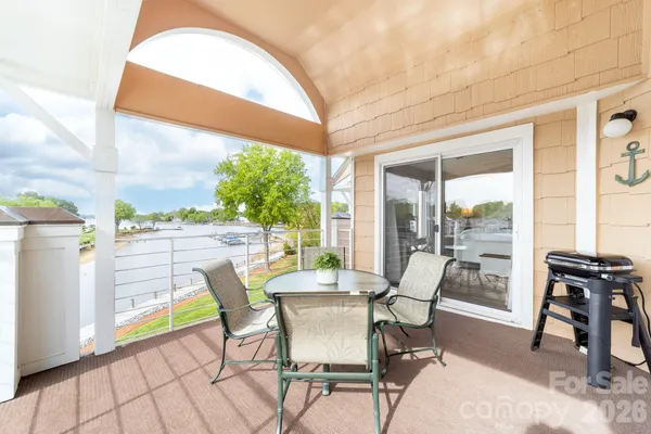 a dining room with furniture and a floor to ceiling window