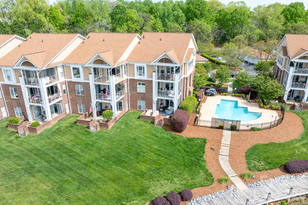 a view of a house with a yard and sitting area