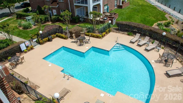 a view of a swimming pool with outdoor seating