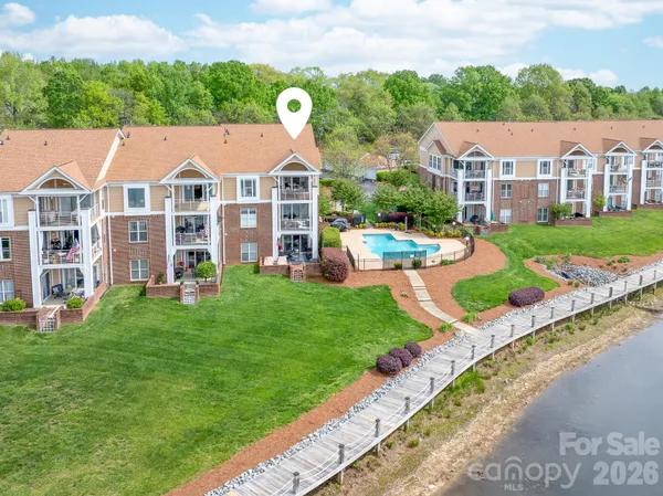 a aerial view of a house with yard and green space