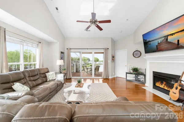 a living room with furniture large window and a fireplace