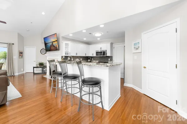 a view of kitchen with cabinets and wooden floor